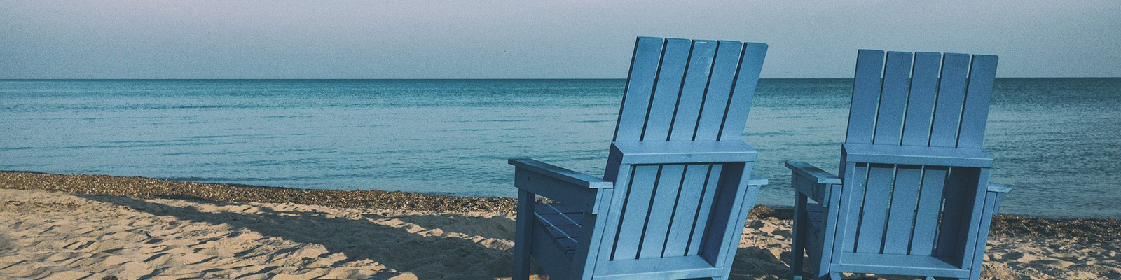 Adirondack chairs on beach